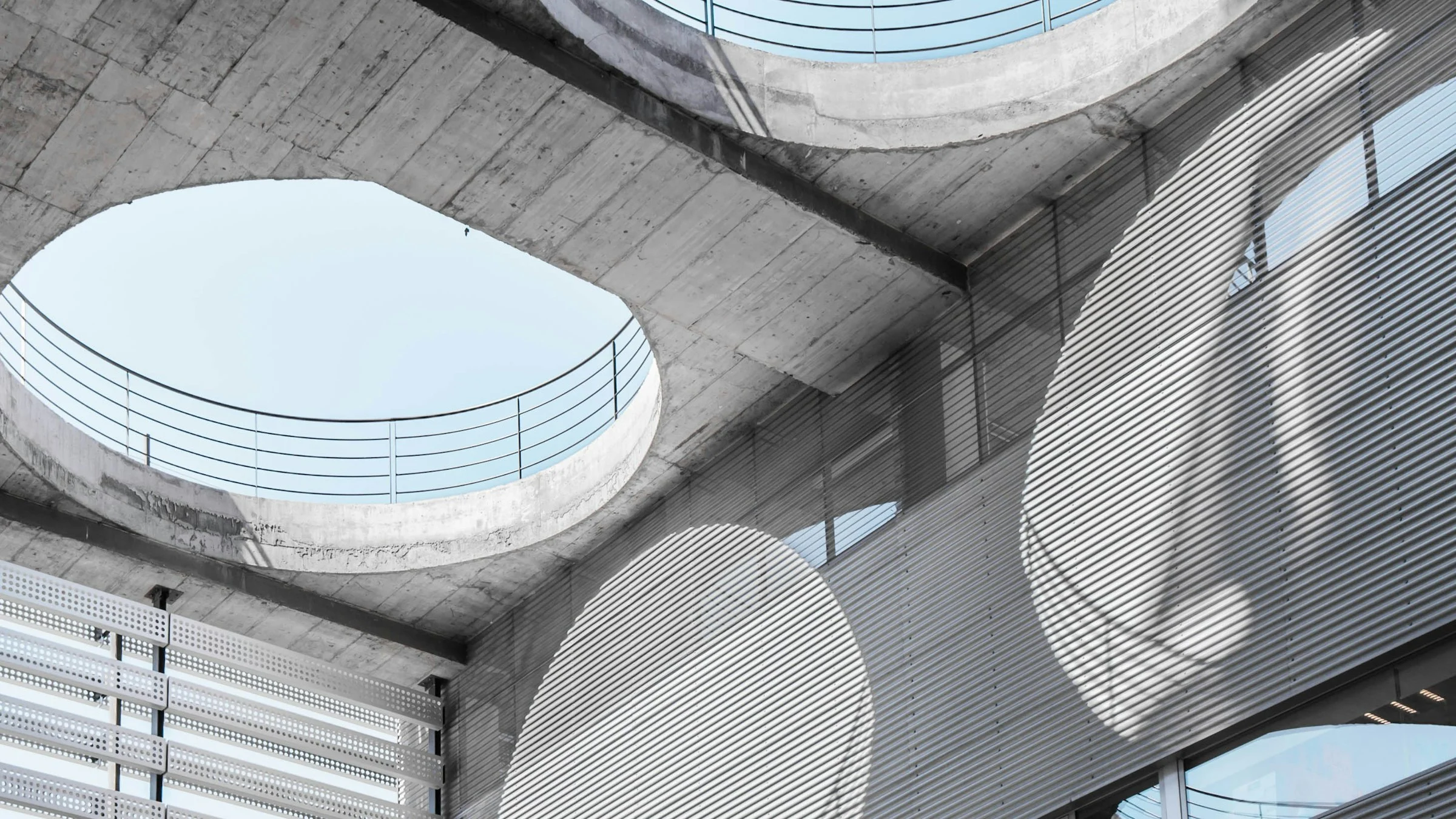 Concrete atrium with round skylights, seen from below